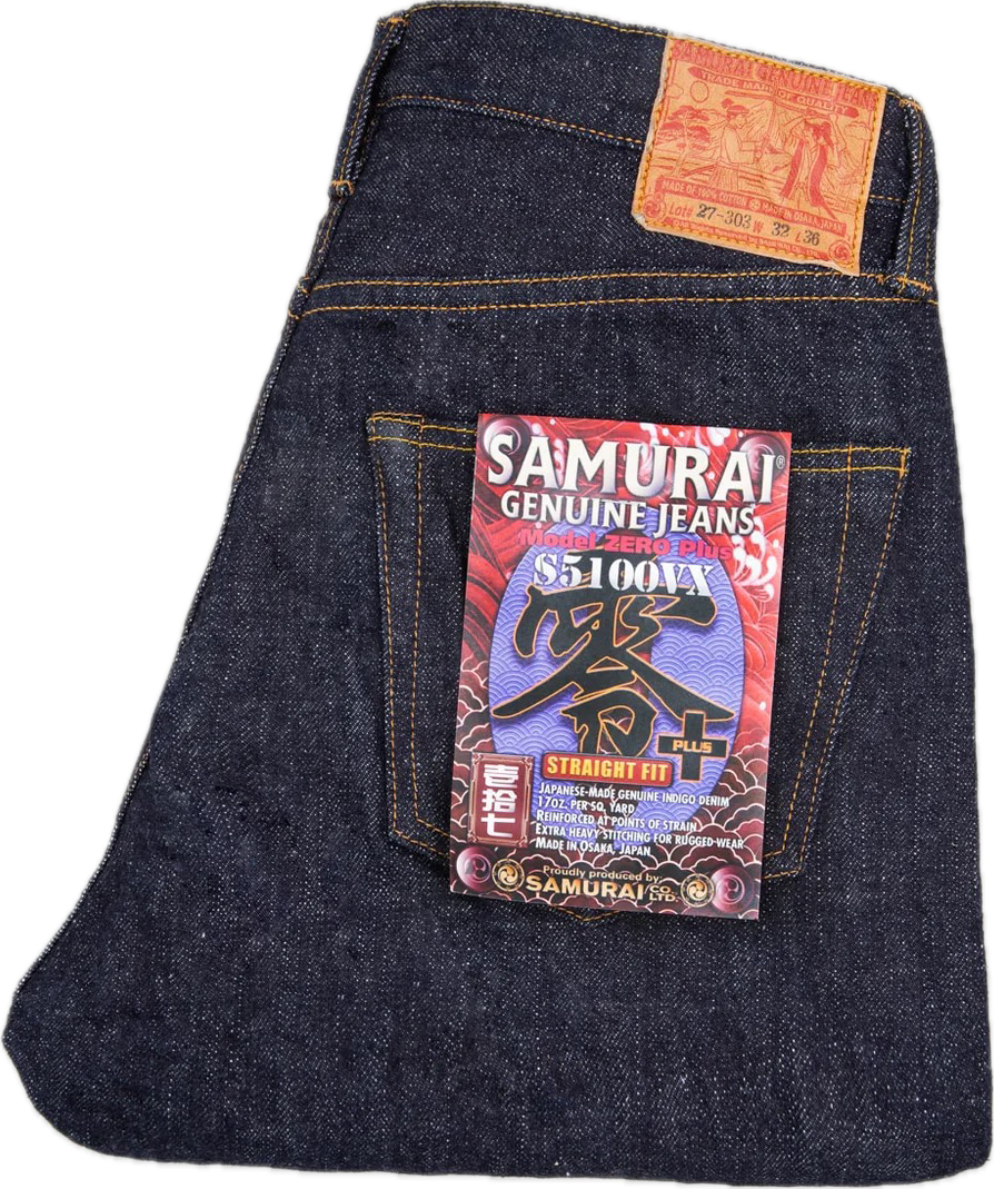 Raw indigo Japanese selvedge denim jeans, folded, showing the selvedge ID and deep indigo warp threads