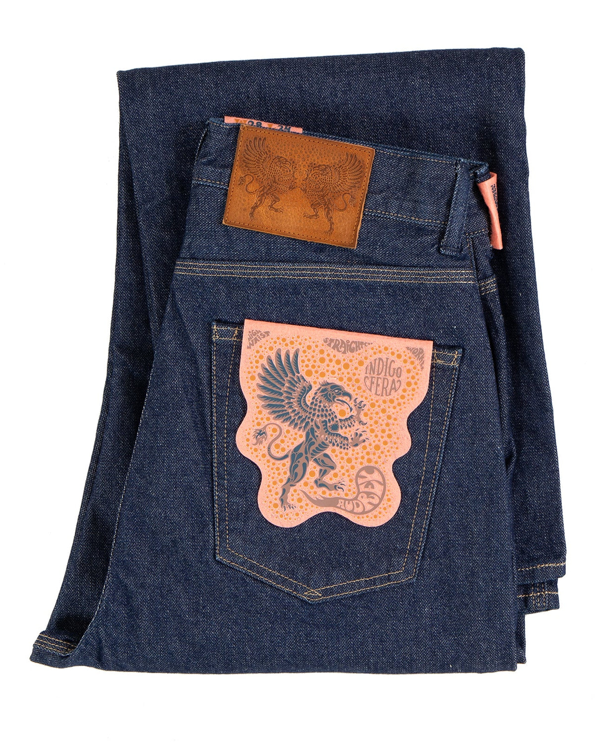 Folded blue denim jeans with Indigofera brand logo