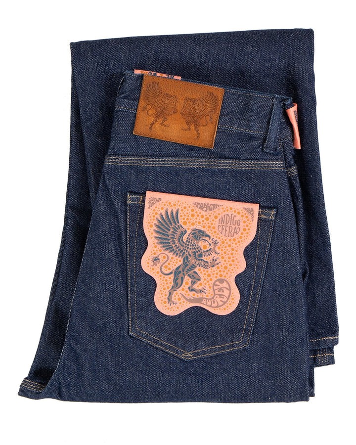 Folded blue denim jeans with Indigofera brand logo